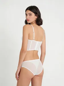 Detailed back view of white lace mesh bustier set with floral embroidery and hook closures