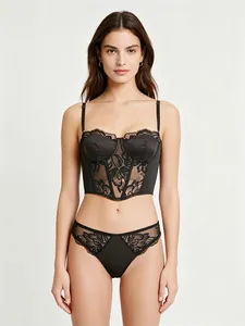 Detail of black lace bustier with floral embroidery and adjustable straps for women