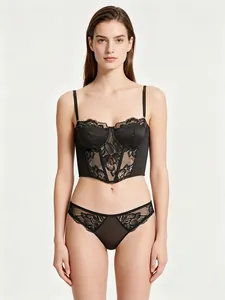 Detail of black lace corset bra with floral patterns and matching lace panties
