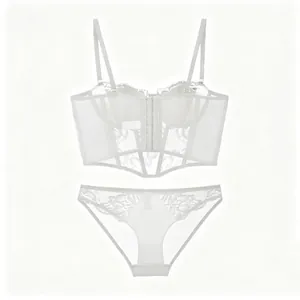 Macro detail of white floral lace and semi-transparent mesh on corset-style lingerie set