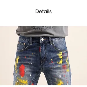 Men's slim fit distressed blue denim jeans with vibrant artistic paint splatter design