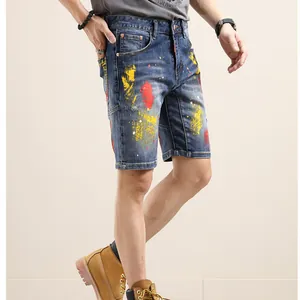 Men's blue paint splatter denim shorts featuring artistic street style wash finish