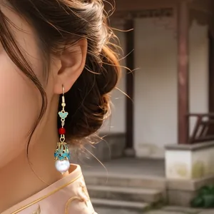 Model wearing vintage Chinese style tassel earrings with blue enamel and white pearls