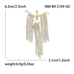 Detail view of gold brooch with long rhinestone tassels and size measurements
