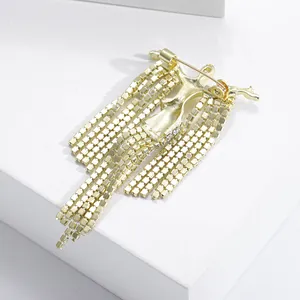 Elegant gold brooch with cascading crystal tassels and polished metal finish for women