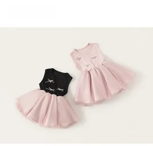 Detailed close-up of pink tulle mesh skirt layers and delicate ribbon bows on toddler dress