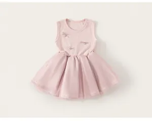Detail of pink sleeveless tulle dress with sequined bow accents and ribbed knit bodice