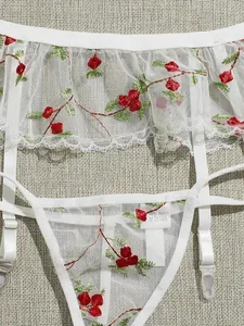 Three-piece white mesh lingerie set with red berry embroidery and ruffled garter belt