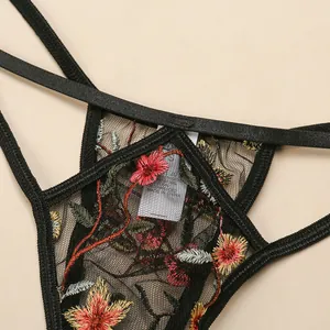 Close-up of black lace embroidery floral pattern with satin trim and brand wash label