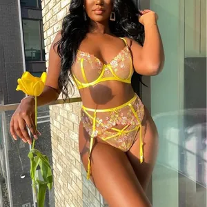 Three-piece yellow mesh lingerie set with floral embroidery and garter belt