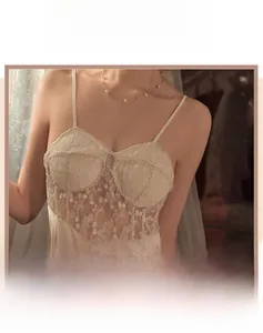 Close-up of elegant floral lace stitching and premium satin fabric on silk nightdress