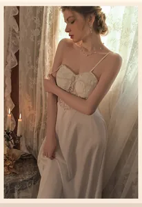 Detail of white satin nightgown featuring intricate lace patchwork and retro French style