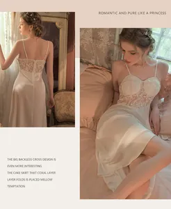 Detail of white satin nightdress with lace embroidery and criss-cross back design