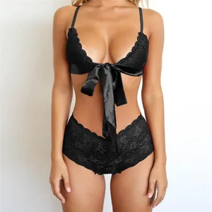 Three-piece black lace bikini set with halter bra, satin bow, and high-waisted panty