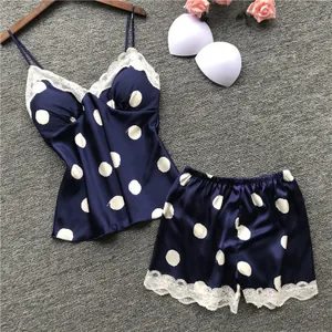 Cute two-piece navy blue satin pajama set with white polka dots and lace trim for women