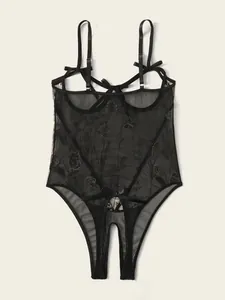 Macro detail of black mesh teddy with floral embroidery and delicate bow accents