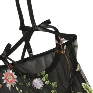 Black mesh bodysuit featuring colorful floral embroidery and adjustable bow straps
