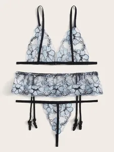 Detailed close-up of light blue floral lace lingerie set with black mesh embroidery