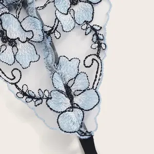 Lingerie set in light blue lace embroidery with floral patterns and black mesh detail