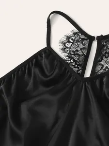Detail of black satin sleepwear featuring delicate eyelash lace trim and silk-like finish