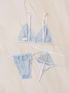 Flat lay of light blue lace lingerie set with eyelash trim and floral patterns