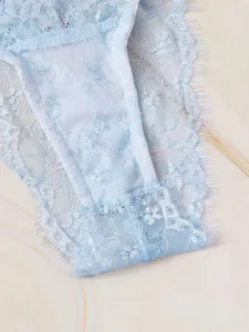 Close-up of light blue floral eyelash lace fabric and detailed stitching on lingerie