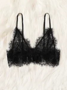 Sexy black eyelash lace bralette with thin spaghetti straps on white plush background