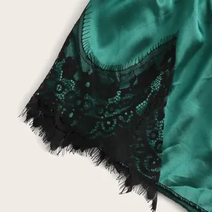 Dark green satin lingerie camisole with black eyelash lace trim and silk texture