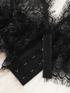 Macro view of floral eyelash lace with three-row metal hook-and-eye back closure