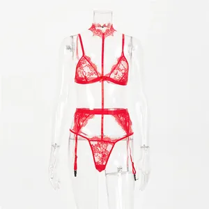 Detail of red lace lingerie set featuring sheer floral patterns and delicate bow accents