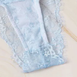 Detailed close-up of light blue floral lace lingerie panty with eyelash trim edge