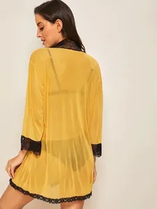 Sexy sheer yellow mesh robe with black lace trim, back view on professional model
