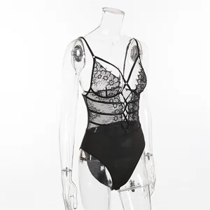 Close-up of floral lace bodysuit with strappy cross-chest detail and mesh texture