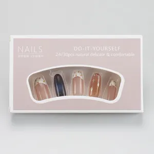 Close-up of pink and blue gradient press-on nails in white packaging with transparent window