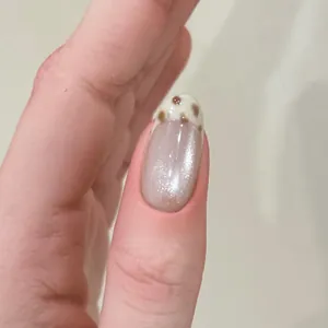 Press-on nail featuring grey glitter base and leopard print French tip design