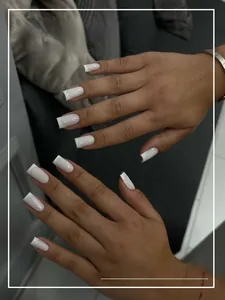 Detailed view of white French square press-on nails with natural soft finish on hands