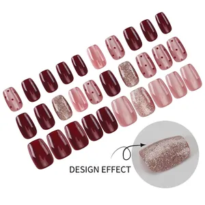 Short square press-on nails in burgundy and pink with glitter and polka dot patterns