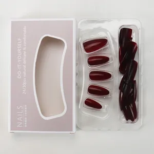 Macro detail of wine red almond press-on nails set in specialized packaging tray