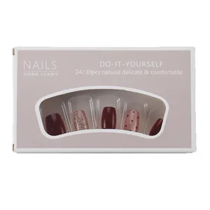 Short press-on nails set in burgundy red, glitter pink, and polka dot brown designs