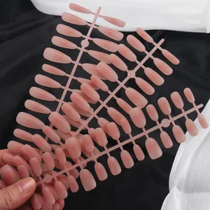 Close-up of nude pink matte gradient press-on nails with semi-transparent texture details