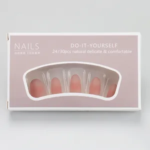 Close-up of matte nude pink gradient press-on nails in professional packaging