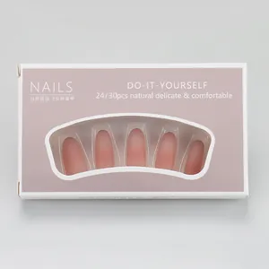 Close-up of pink gradient press-on nails in packaging with coffin shape design