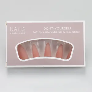 Detail of nude pink matte gradient press-on nails in long almond shape packaging