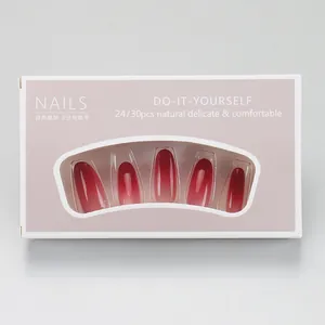 Detail view of burgundy gradient press-on nails in light pink display packaging