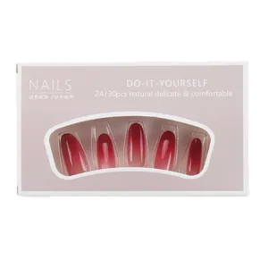 Burgundy gradient press-on nails in long coffin shape with pink minimalist packaging