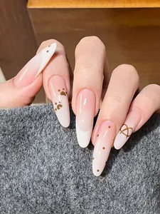 Detail of almond-shaped almond nails with pink gradient and cute brown cat paw patterns