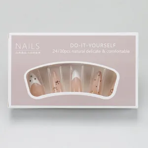 Detail view of long almond press-on nails with nude pink gradient and cute bear paw patterns