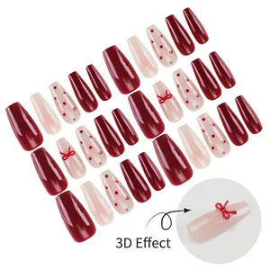 Press-on long coffin nails with red cat eye gradient, polka dots, and 3D bow accents