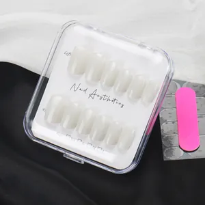 Short milky white press-on nail set with file and jelly adhesive on silk background
