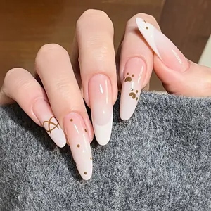 Long almond gradient press-on nails with pink base, brown polka dots, and heart patterns